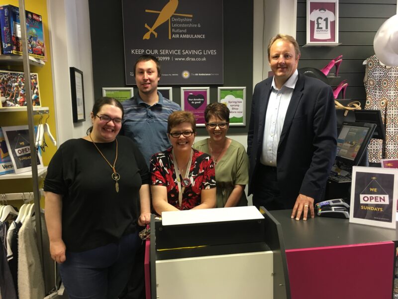 Toby with volunteers at the Air Ambulance charity shop on Burlington Street