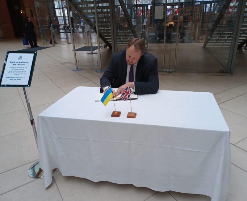 Toby signing the Book of Solidarity with the people of Ukraine in the House of Commons