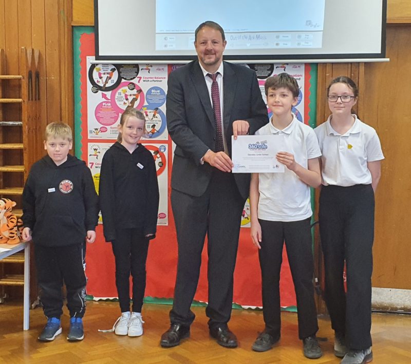 Toby presenting the certificate to students at Staveley junior School